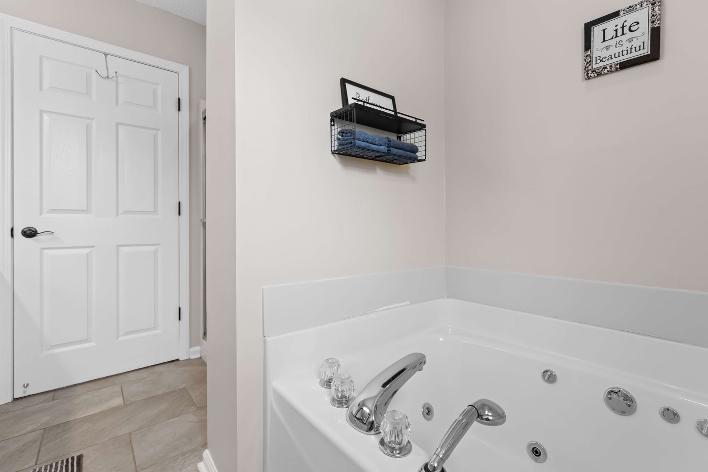 Primary ensuite bathroom jetted soaking tub beside a window