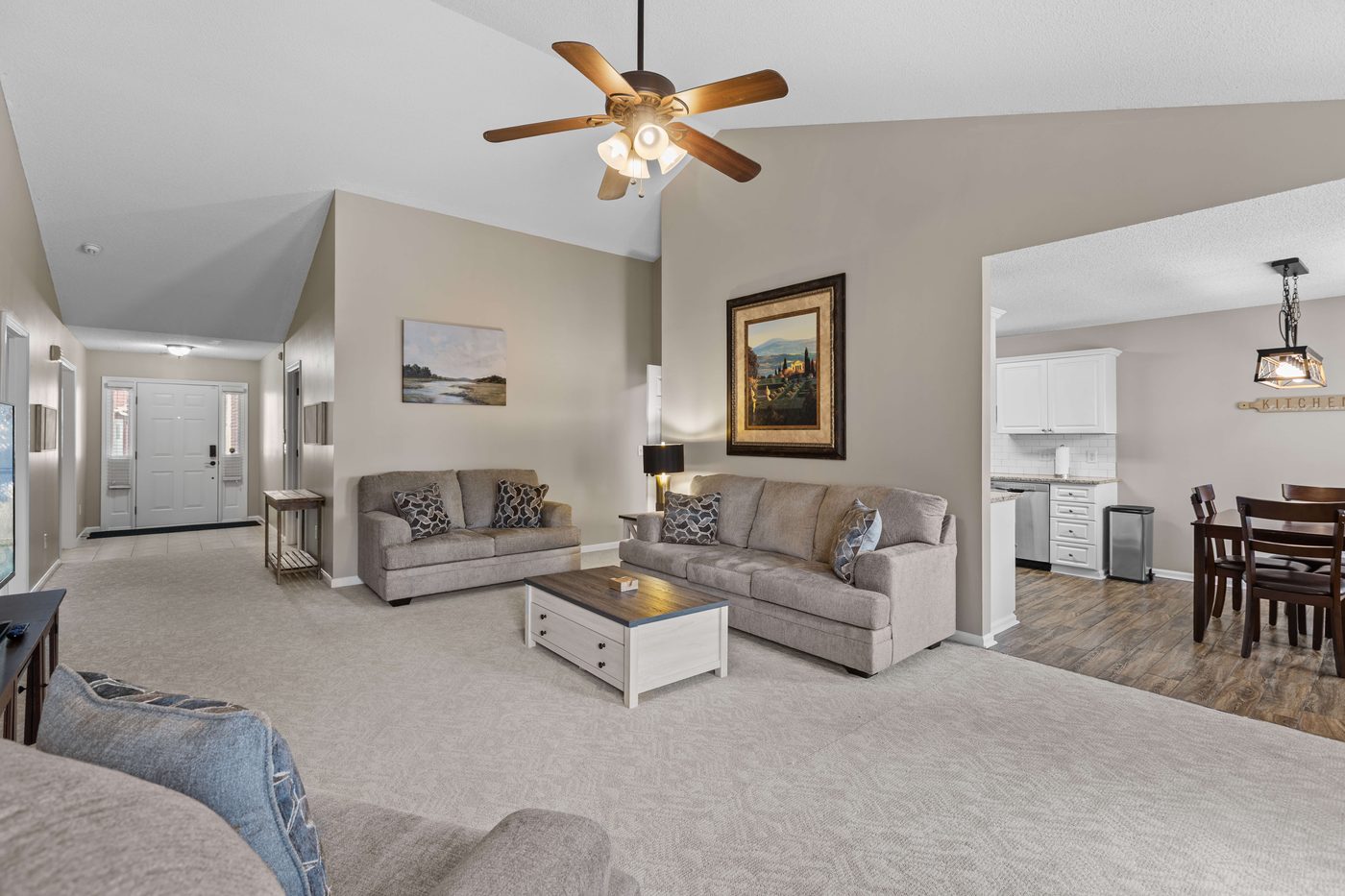 Open concept great room looking from the living room toward the kitchen and dining area