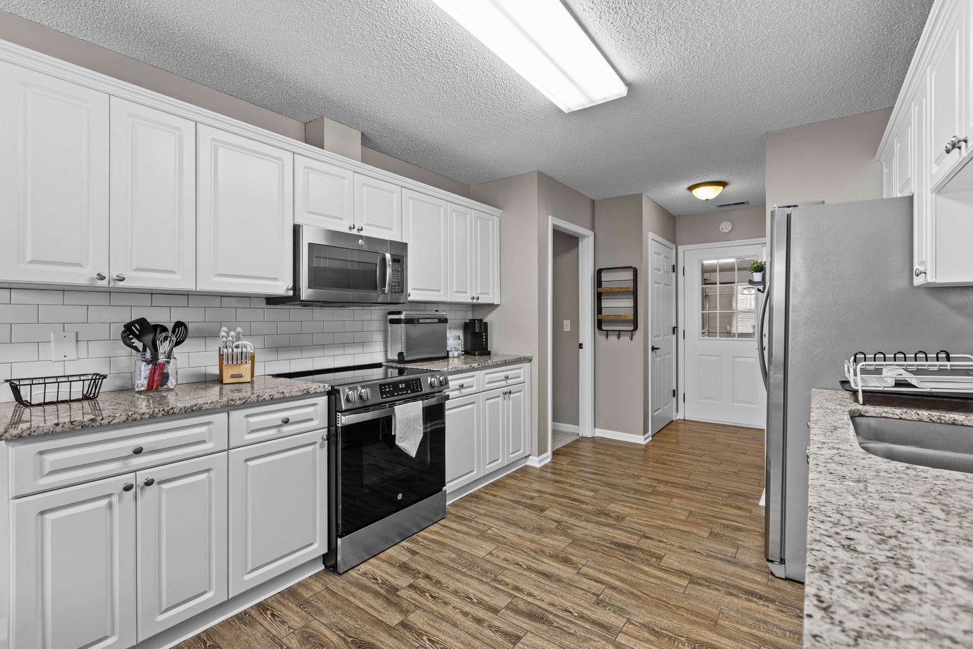 Kitchen with a stainless steel range, oven, microwave, and refrigerator