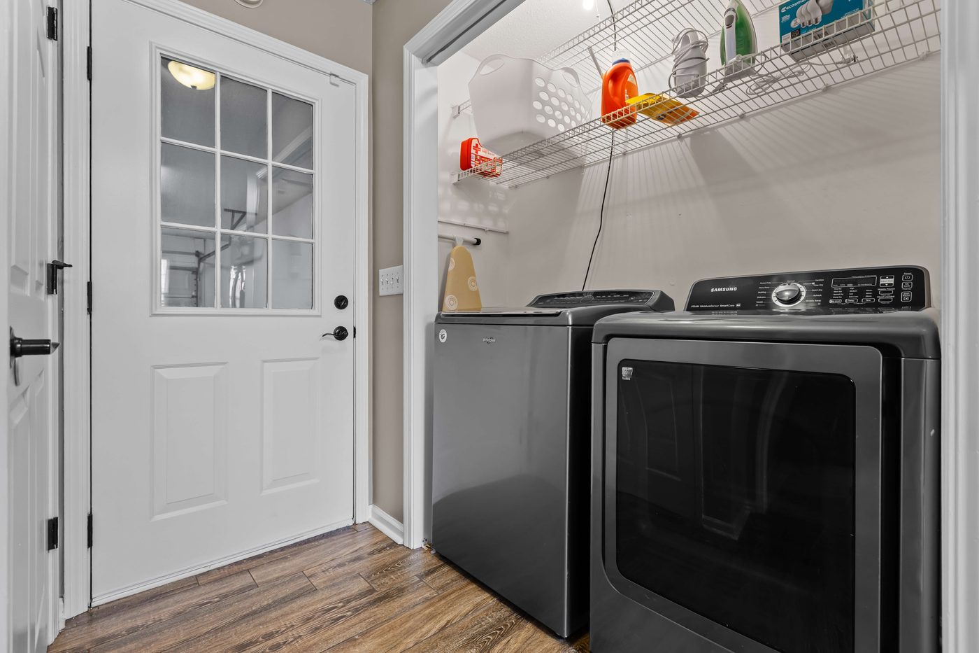 Laundry room with a full-size washer and dryer and an exterior door